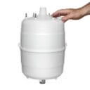A hand gently touches a white cylindrical container with multiple protruding connectors on top.