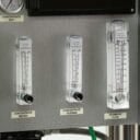Flowmeters for concentrate recirculation, drainage, and permeate flow mounted on a metallic panel with labels.